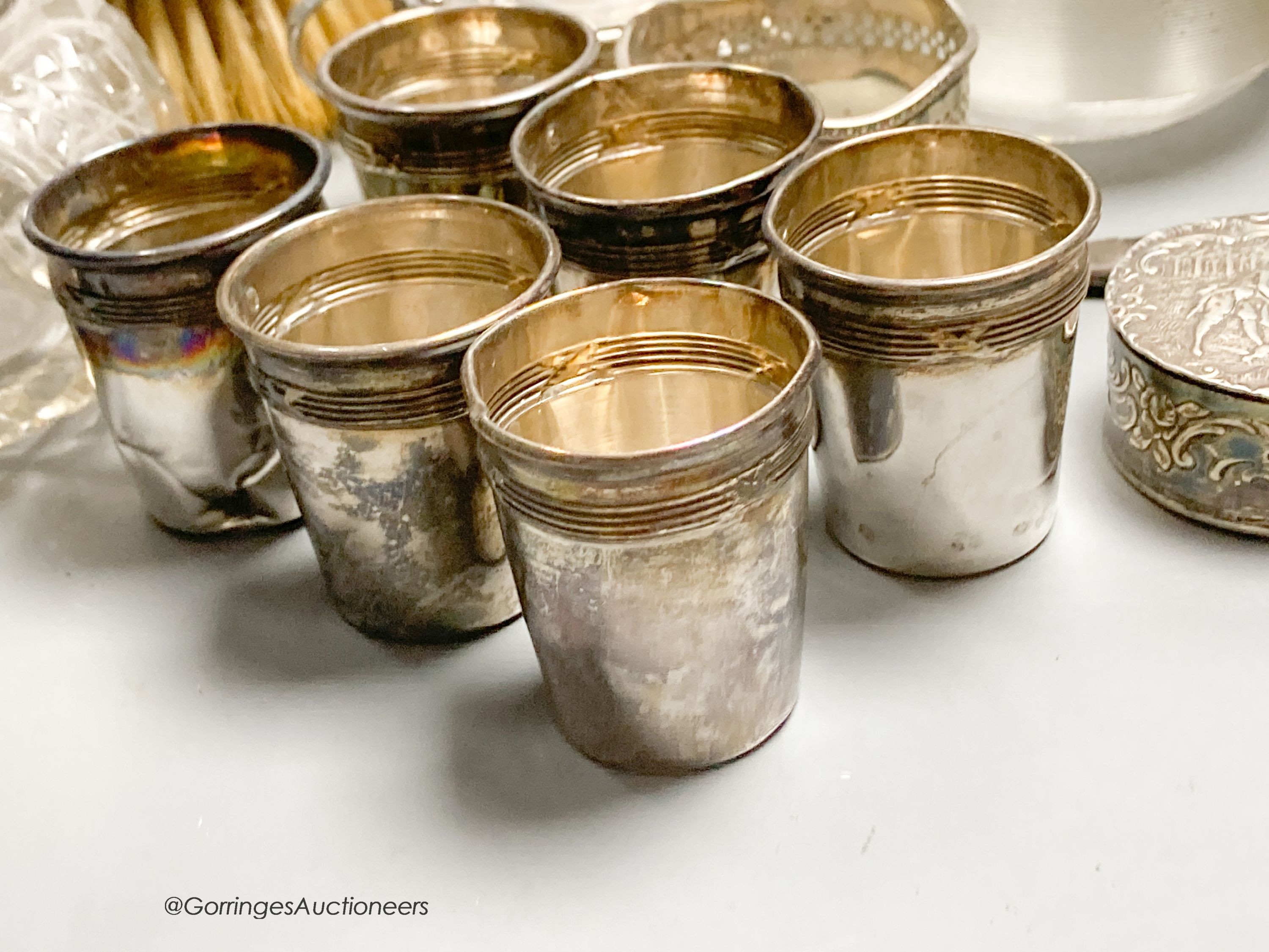 Sundry small silver including a trophy goblet, 22.5cm, napkin rings, two photograph frames, match tidy, spill vases, brushes, white metal tots and box etc.